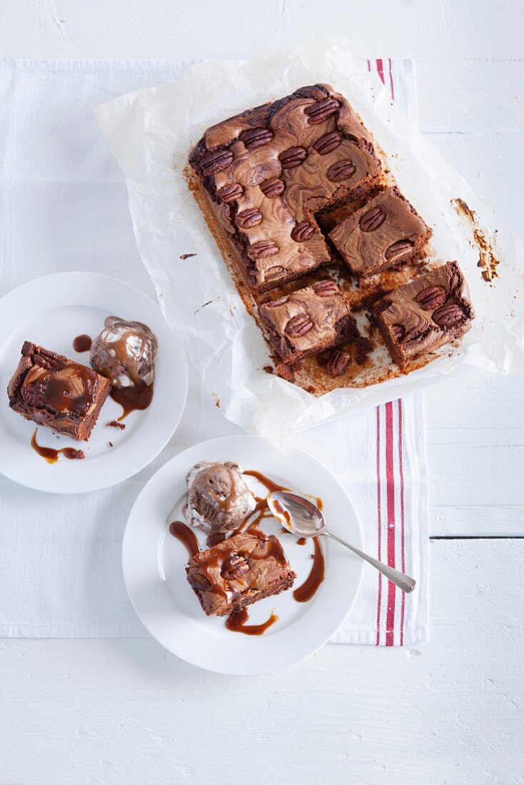 Brownies with pecan nuts, ice cream and caramel sauce