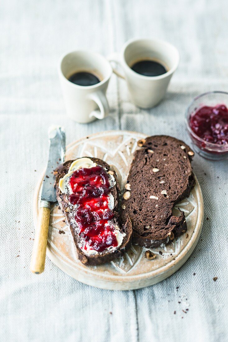 Chocolate bread with hazelnuts served with butter and jam