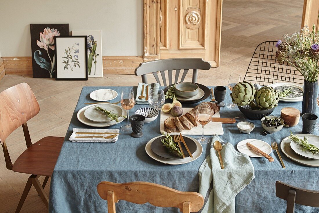 A table laid à la Provence with a blue linen tablecloth and scented decorations