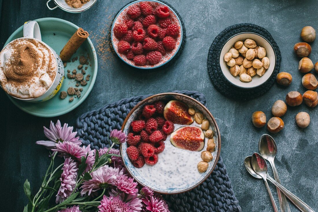 Hot chocolate and muesli with raspberries, figs and nuts