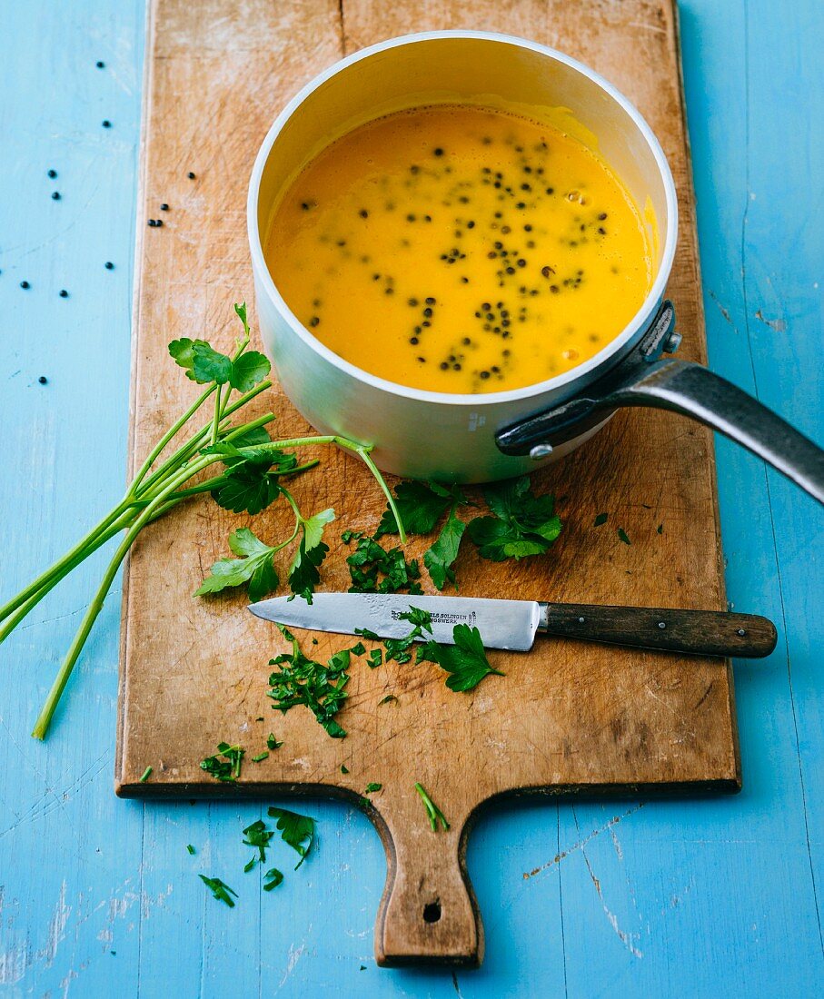 Gluten-free pumpkin soup with black lentils and fresh herbs