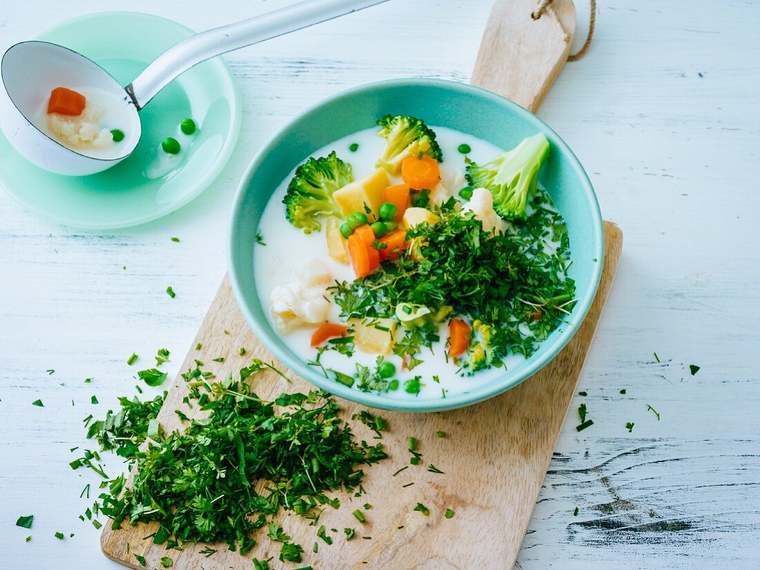 Swedish potato soup with some vegetables and fresh herbs