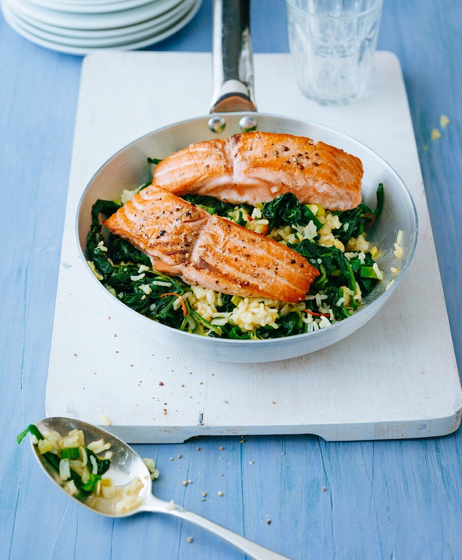 Fried rice with spinach and fried salmon