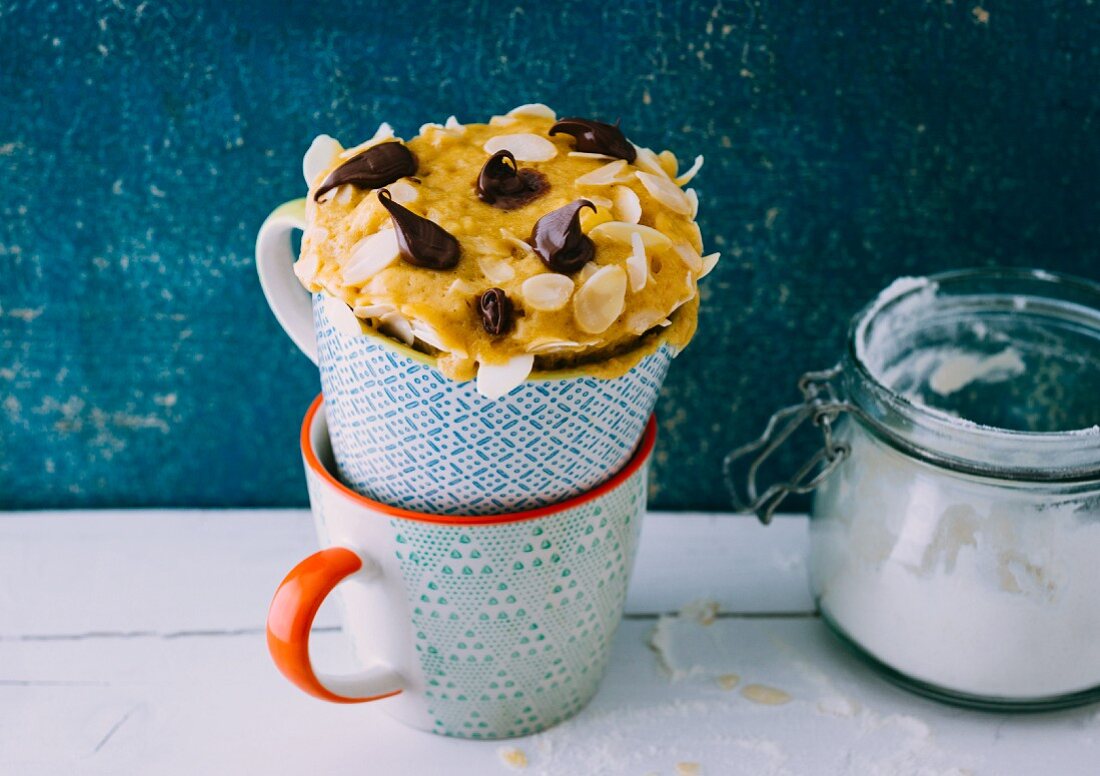 A banana boat-style mug cake with bananas and chocolate cream