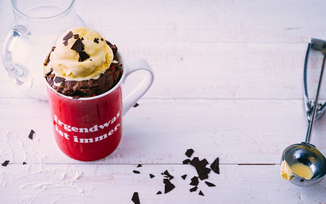 A chocolate mug cake with chilli flakes and vanilla ice cream