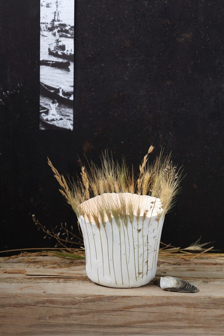 A homemade, papier mâché lantern decorated with ears of grain and grass