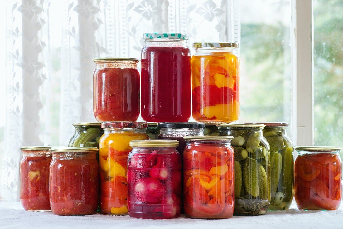 Pickled vegetables in jars on a window sill