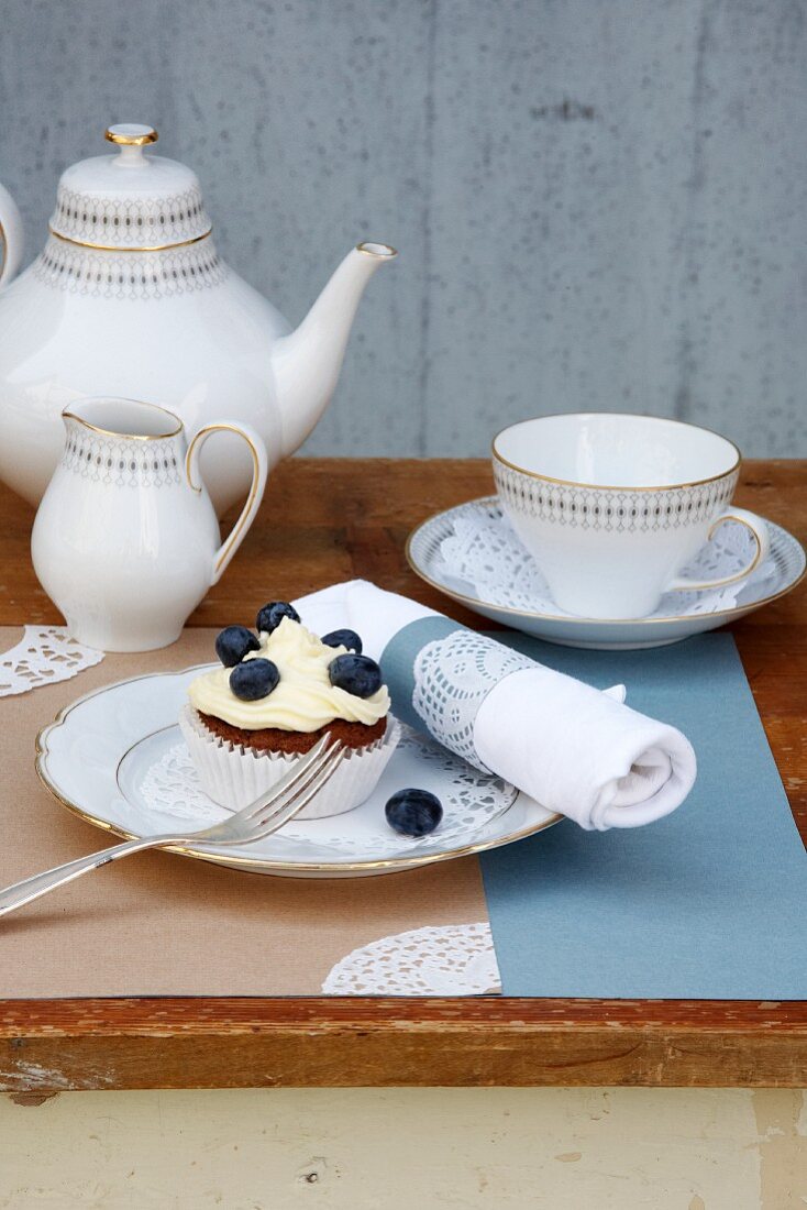 Coffee and cake on outdoor table decorated with vintage-style lace doilies