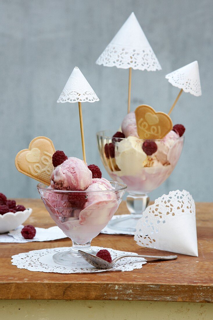 Ice-cream sundae with decorated with parasols hand-made from white doilies