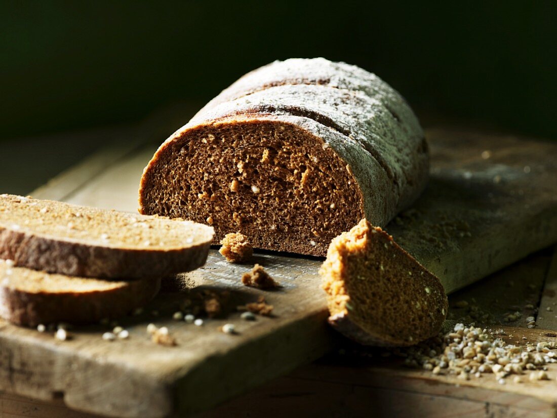Dark spiced bread, sliced, on a chopping board