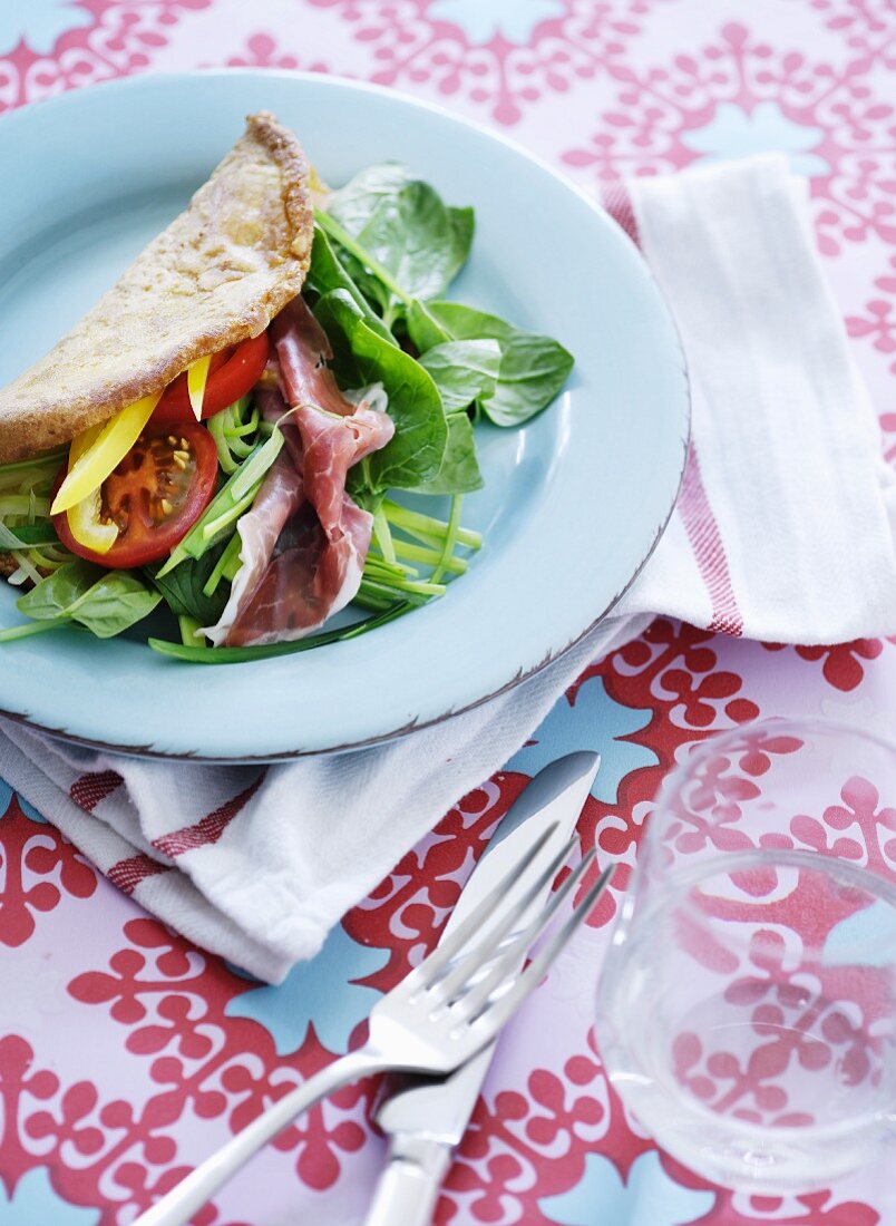 unleavened bread with raw ham and spinach