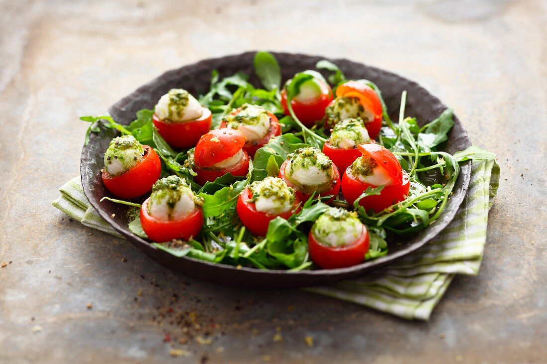 Cocktail tomatoes filed with mini mozzarella on pesto