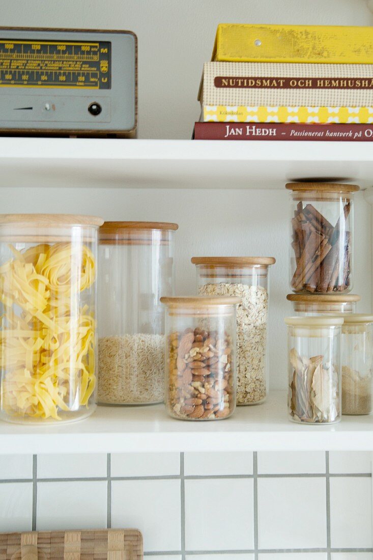 Storage jars and retro radio on kitchen shelves