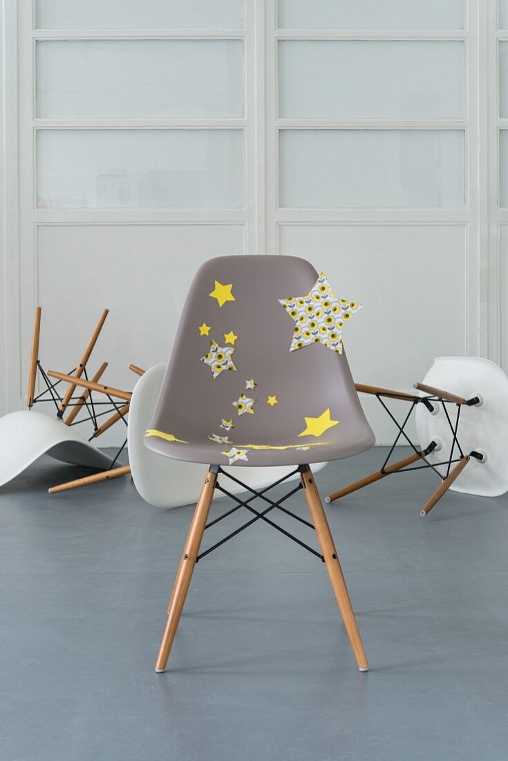 A modern grey chair decorated with fabric star stickers