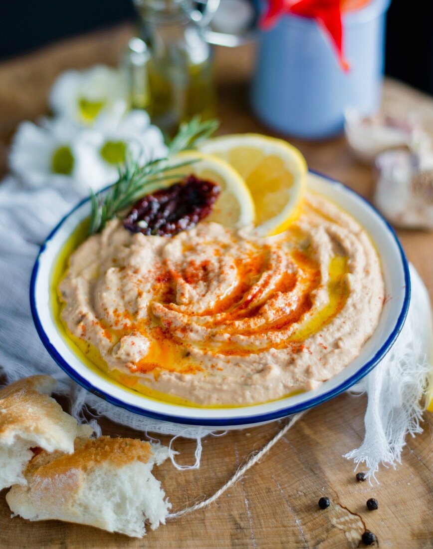 A bowl of hummus with dried tomatoes
