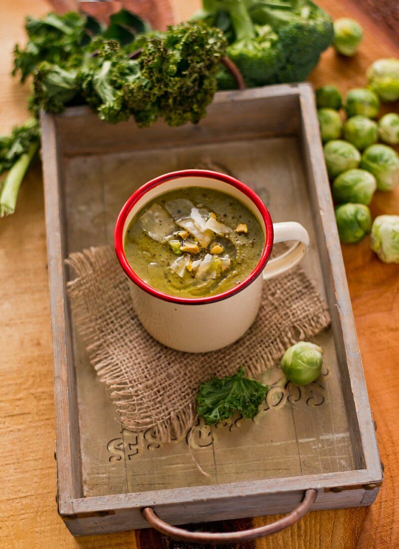 Green cabbage soup in a tin mug