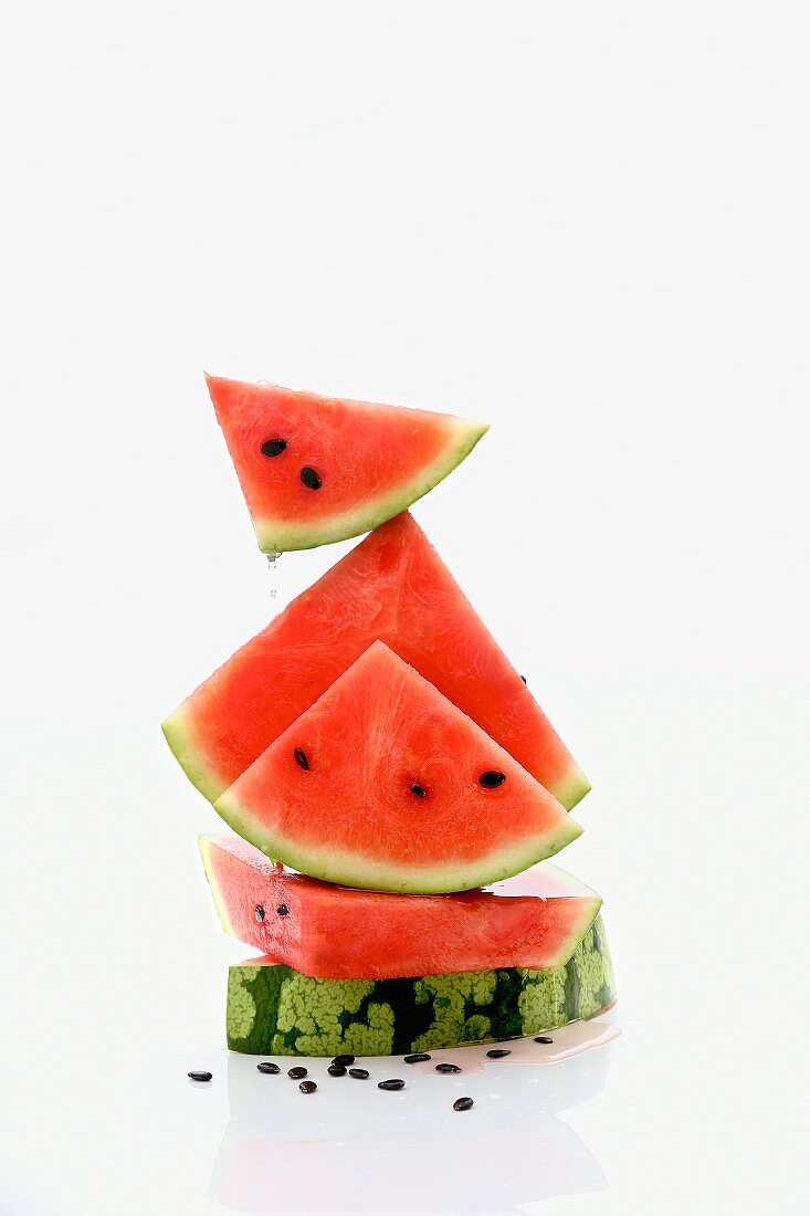 A stack of watermelon slices with seeds