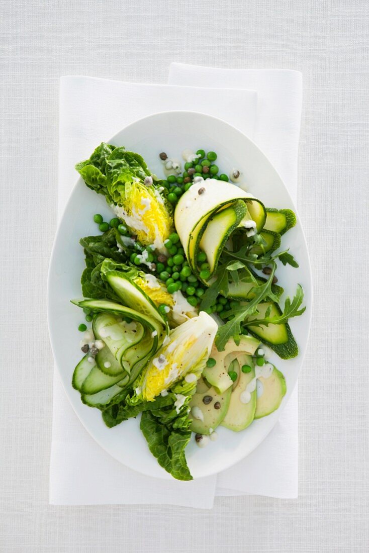 Green vegetable salad with peas, courgette, cucumber and avocado