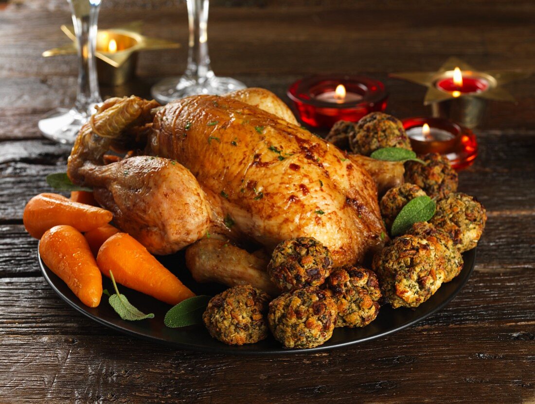 Roast capon with fried bread dumplings and carrots