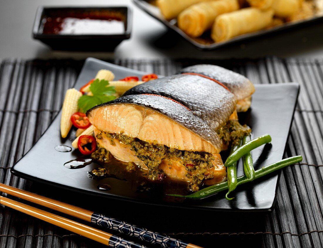Thai-style stuffed roasted salmon with green beans and baby corn