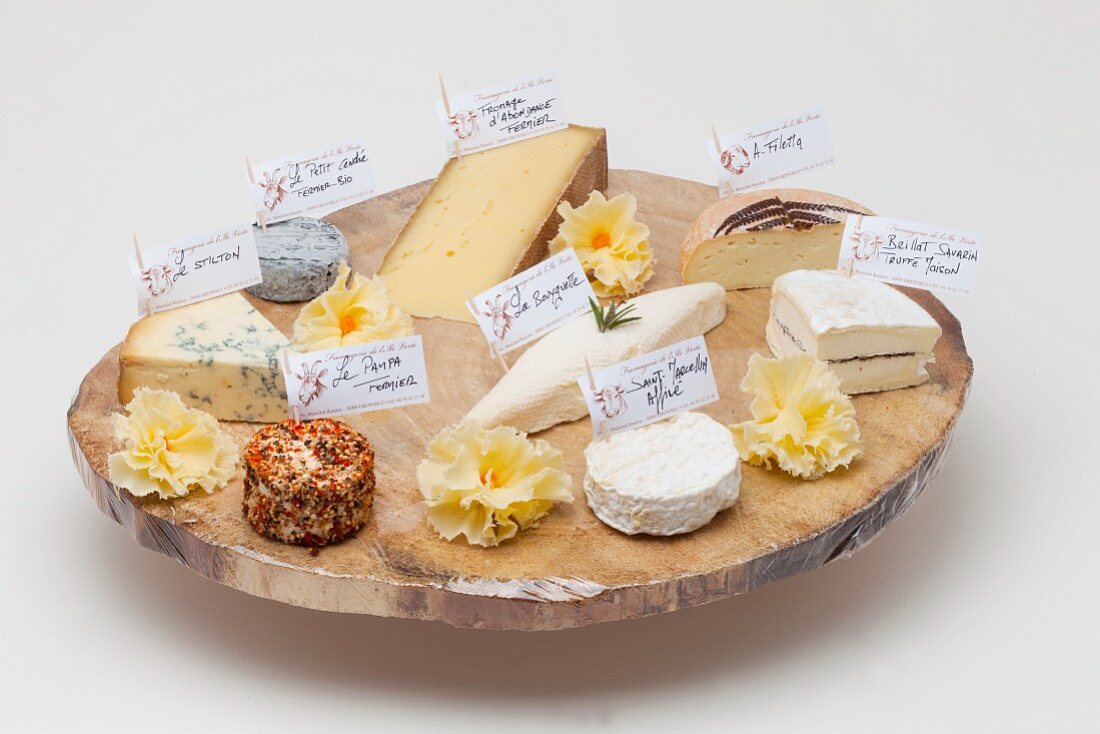 Various types of cheese on a rustic wooden platter