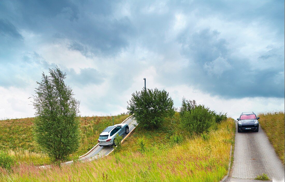 Porsche: a test driver with a Porsche Cayenne on the site in Leipzig, Germany