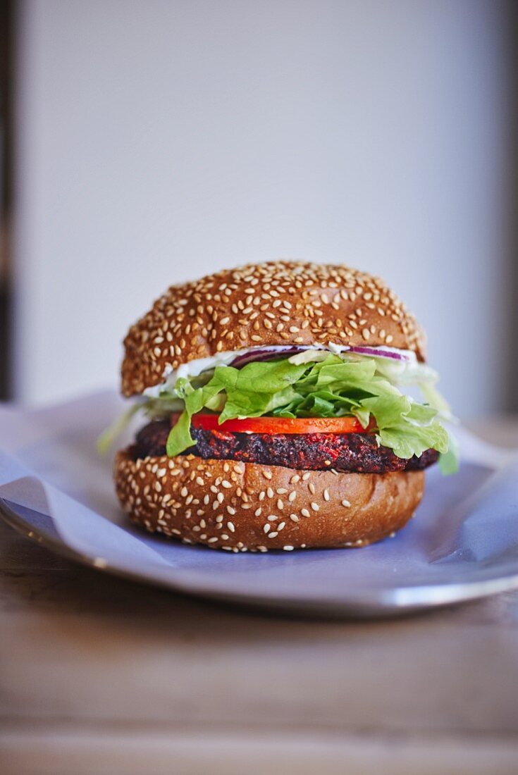 A veggie burger with a beetroot patty