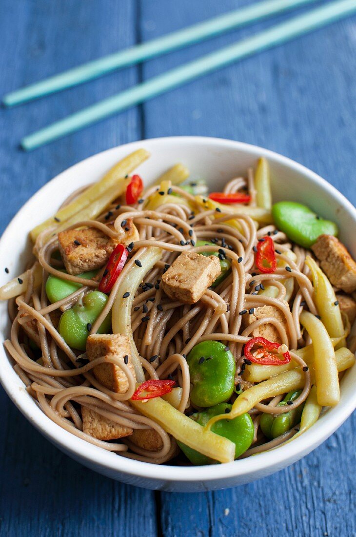 Soba noodles with tofu, broad beans, yellow beans, black sesame seeds and chillis