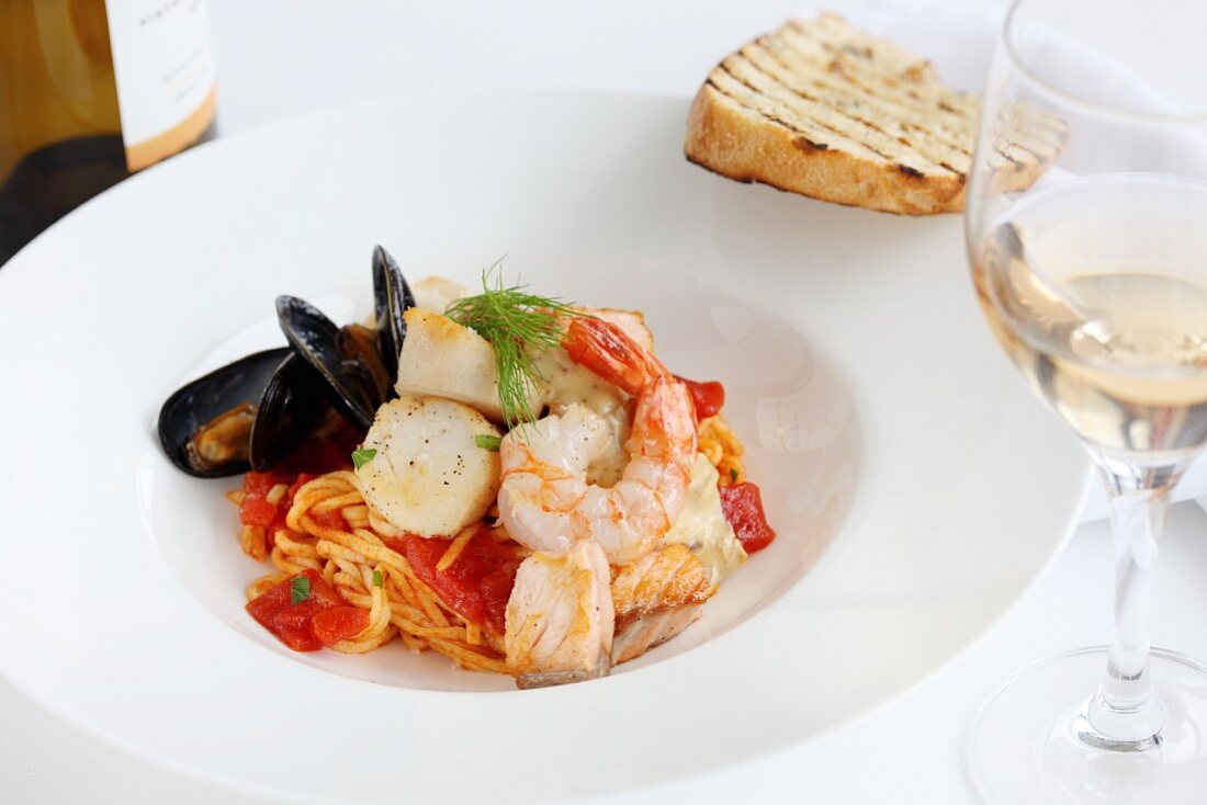 Pasta with tomatoes, fish and seafood