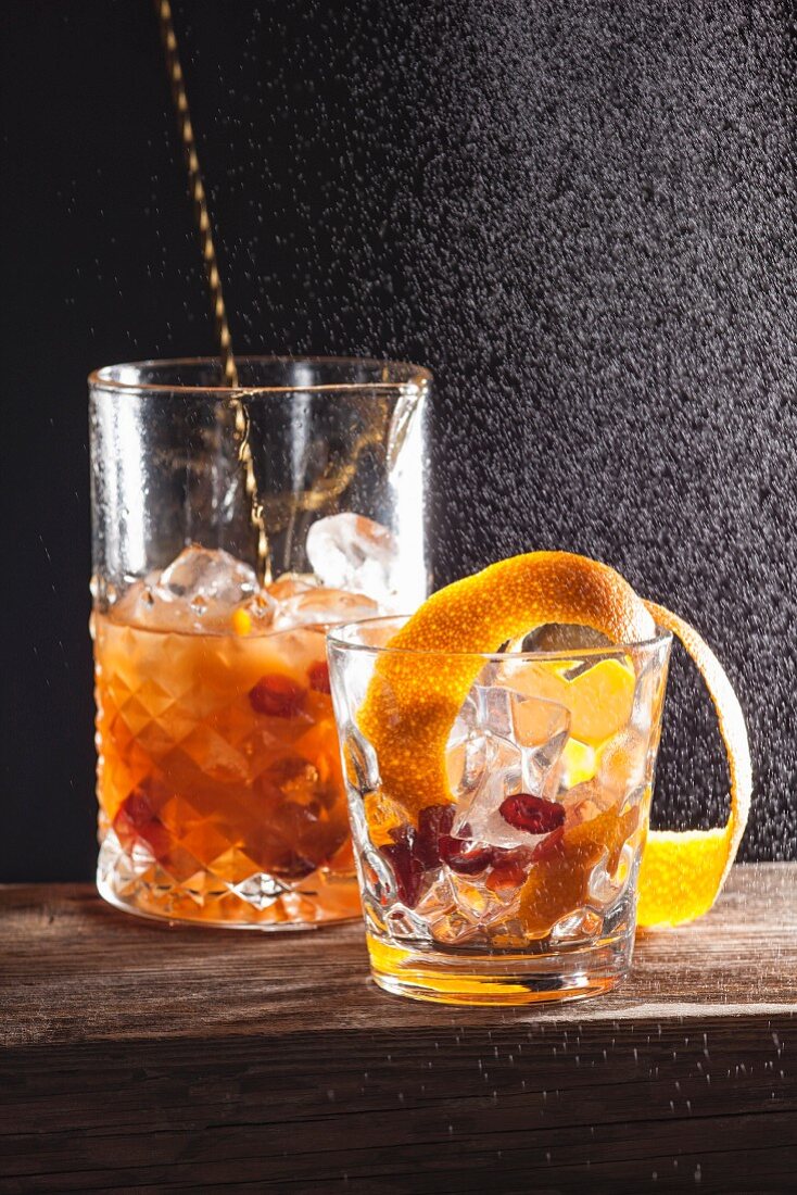 An alcoholic cocktail made with fruits and orange zest