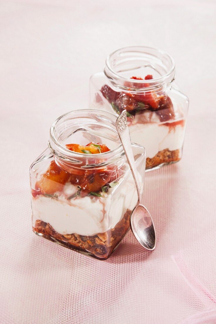 Layered desserts made with muesli, quark and nectarines in jars