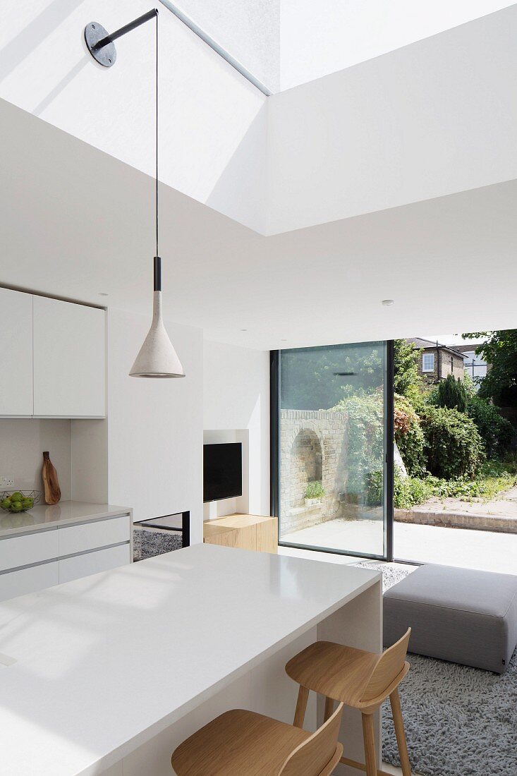 White, modern interior with view of garden