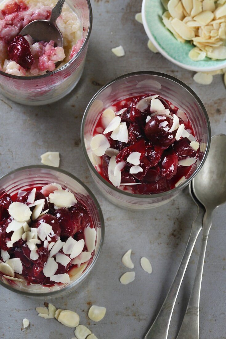 Rice pudding with cherries and flaked almonds (seen from above)
