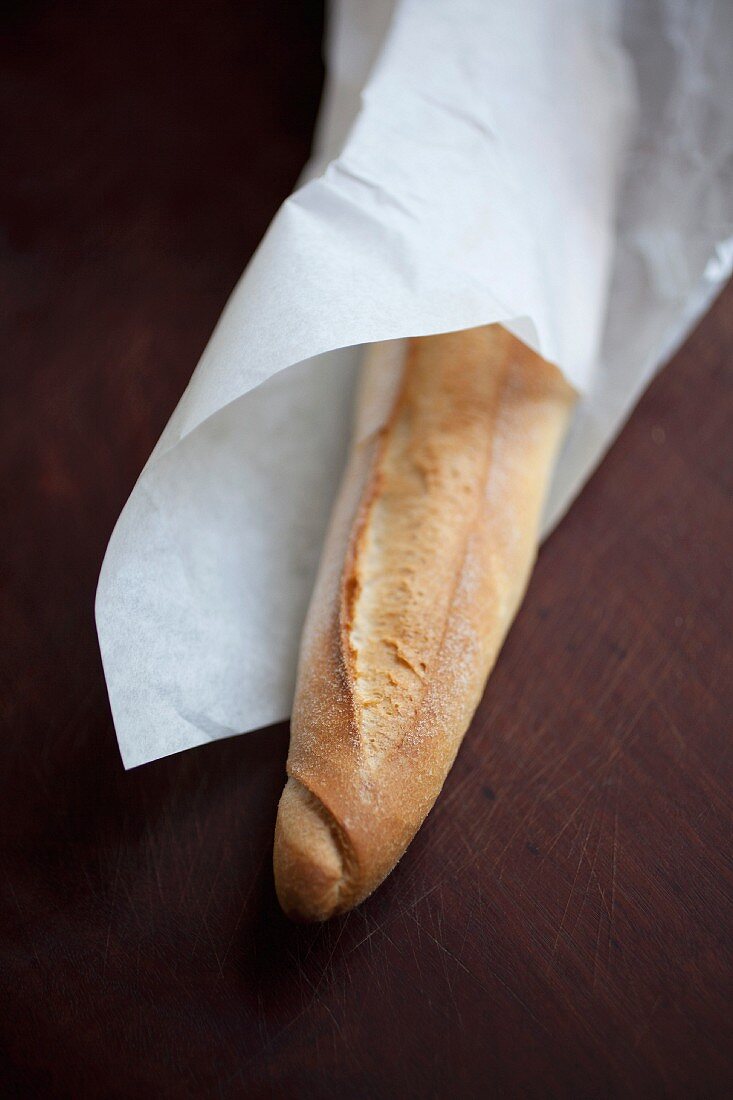 A baguette wrapped in paper
