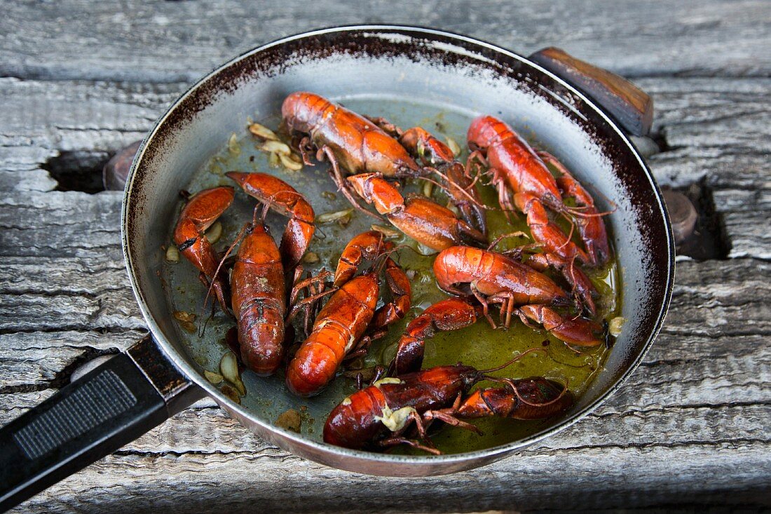 Crayfish fried in butter in a pan