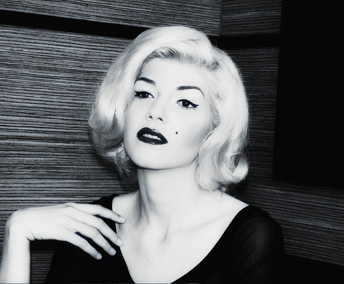 A portrait of a young woman emulating Marilyn Monroe (black-and-white shot)