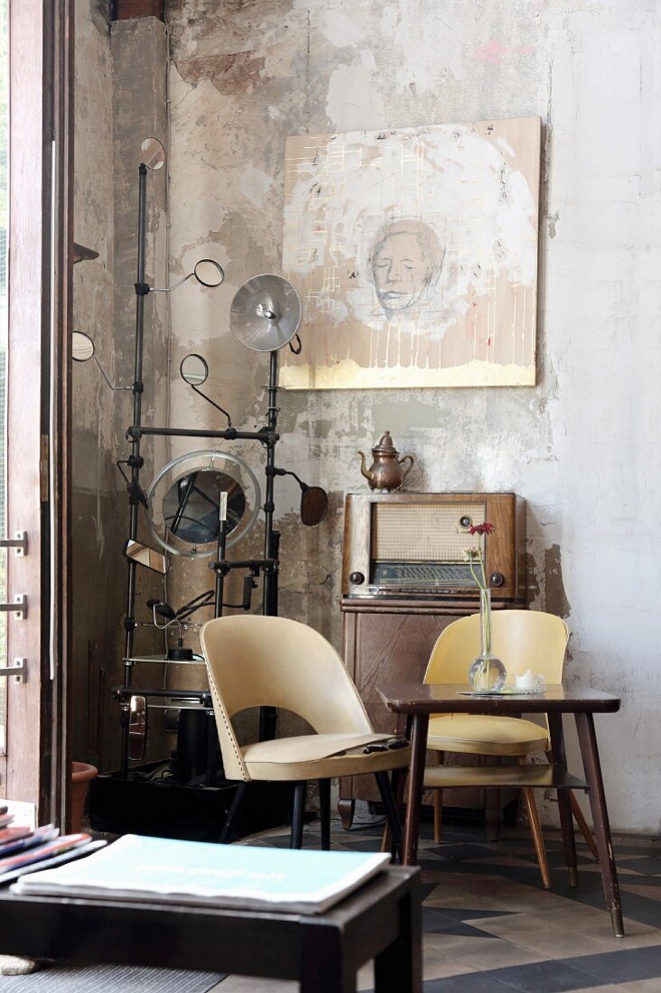 Fifties-style easy chairs with pale plastic covers against unrendered wall in Café Hutmacher, Wuppertal, Germany