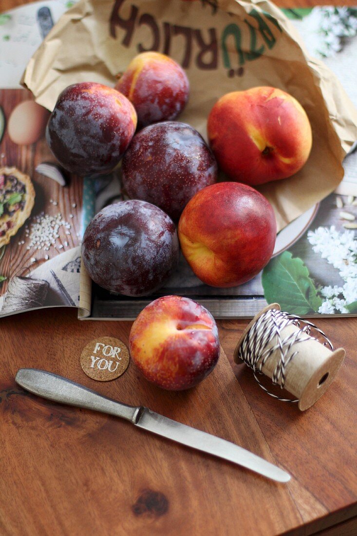 Nectarines and plums on a wooden table