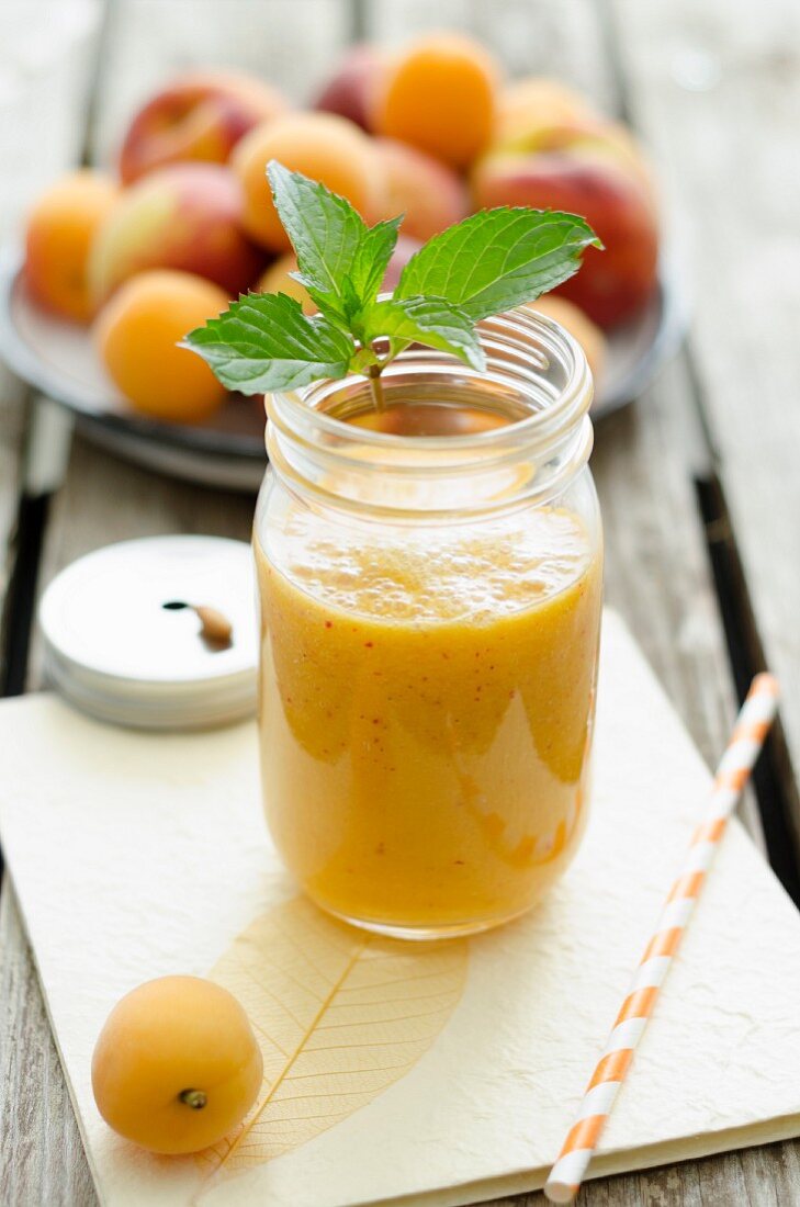 A peach and apricot smoothie in a jar