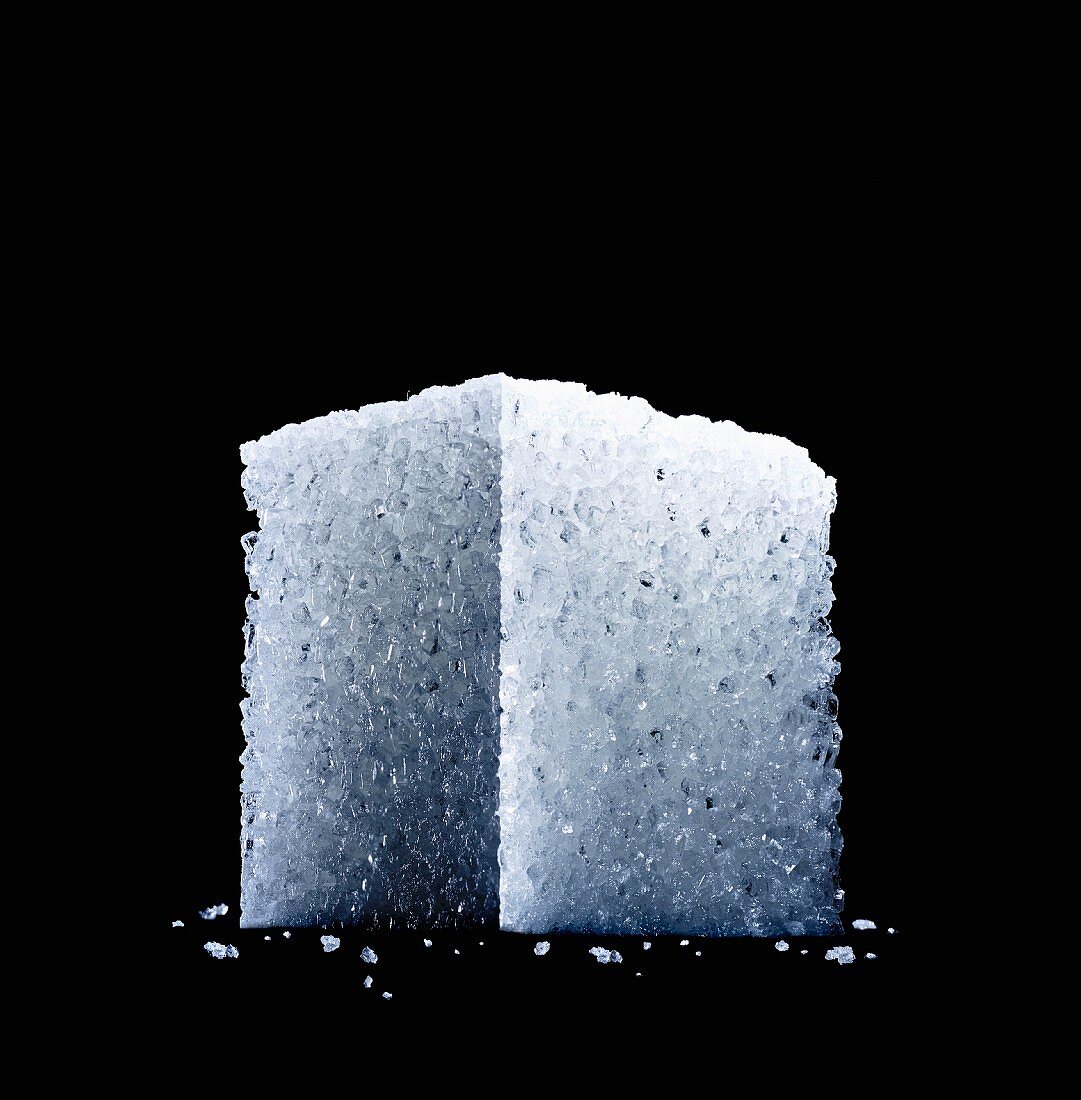 A sugar cube against a black background (close-up, seen from below)
