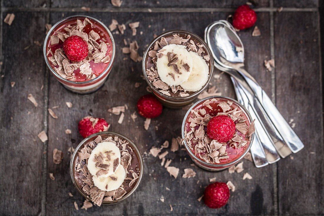 Two different mascarpone desserts with raspberries and chocolate