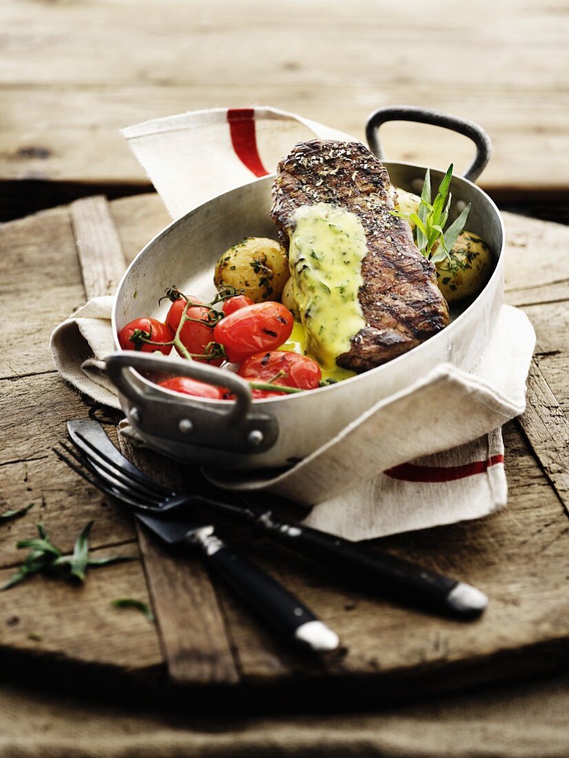 Beef steak with oven-roasted vegetables and herb sauce