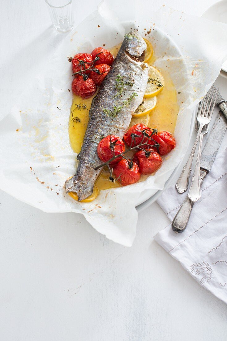 Baked trout with cherry tomatoes and lemon