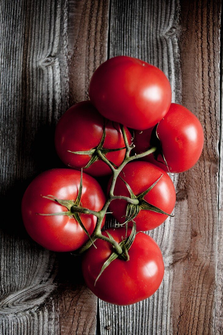 Vine tomatoes on a wooden surface
