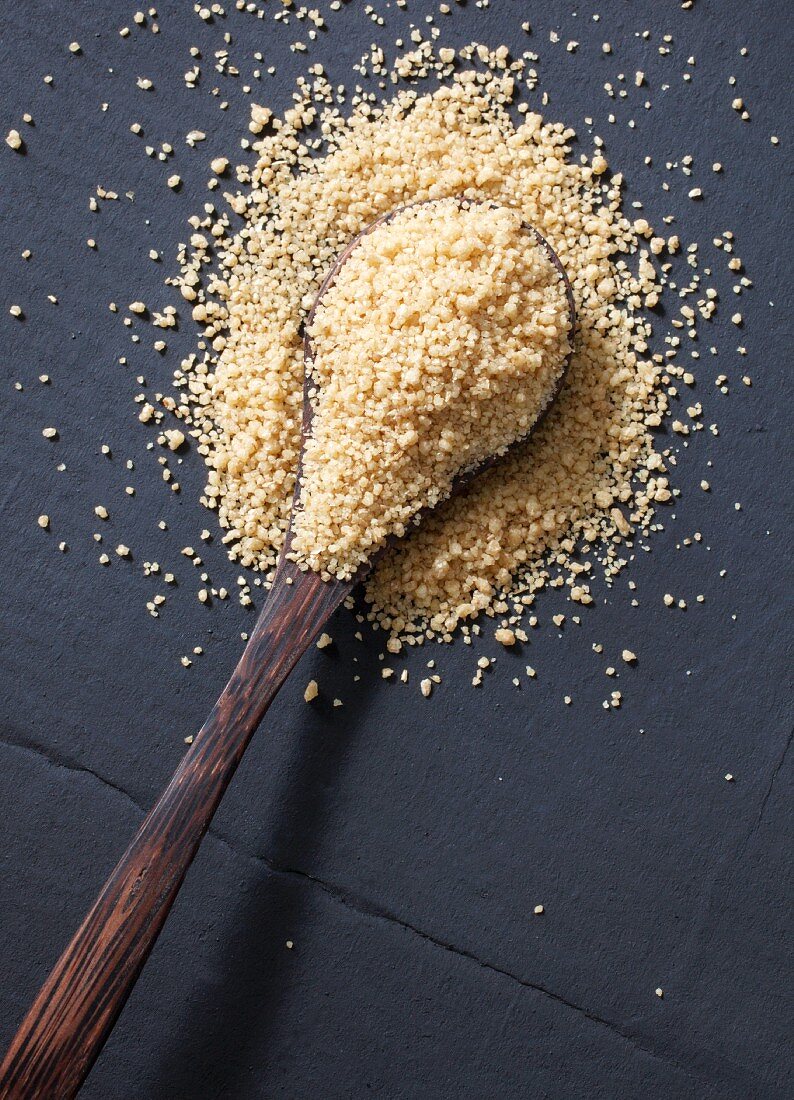 Couscous on a wooden spoon (seen from above)