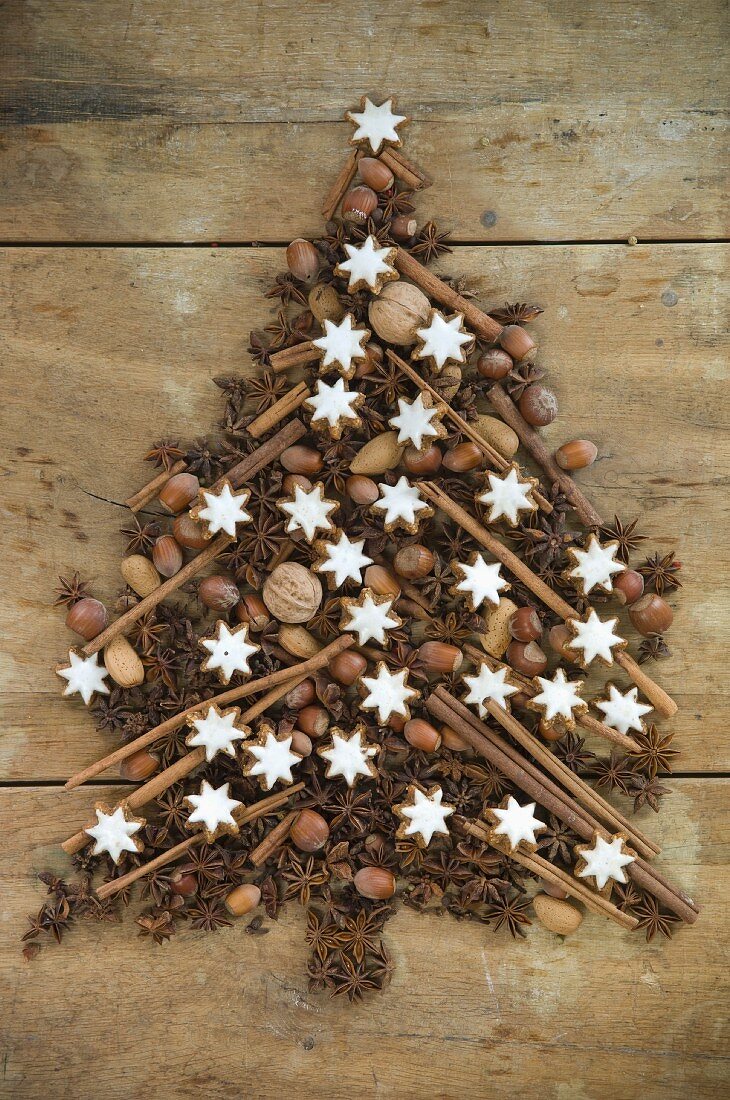 A Christmas tree made from star anise, nuts, cinnamon sticks, cloves and cinnamon star biscuits