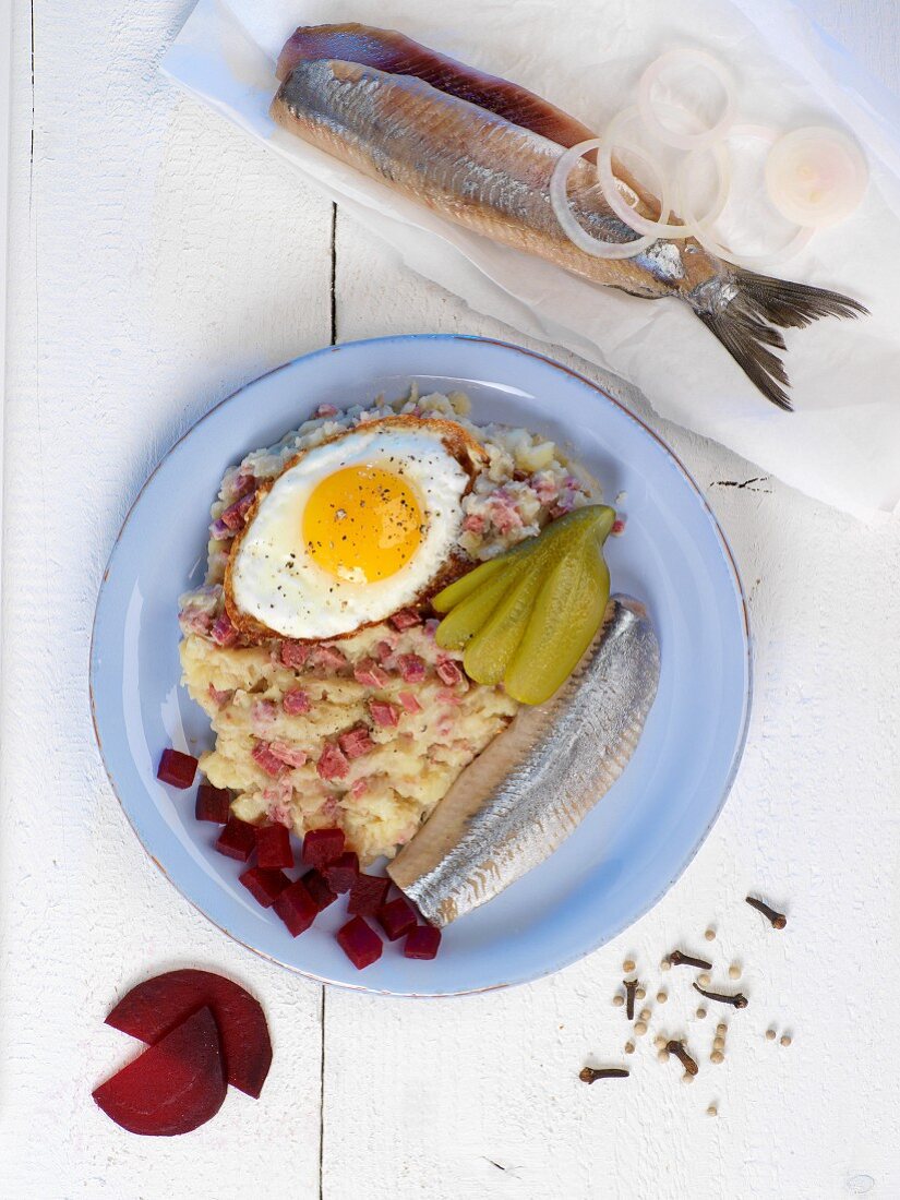 Labskaus (traditional dish from Northern Germany featuring herring, egg and gherkins)