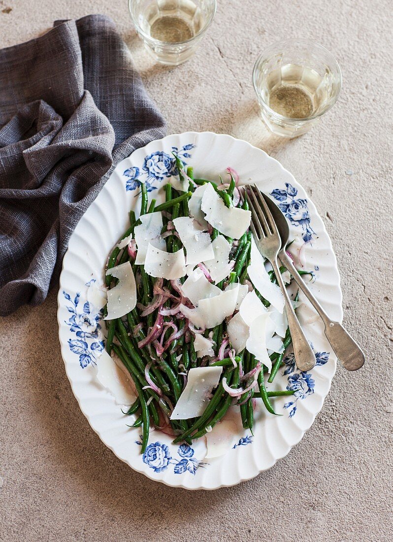 Green bean salad with red onions and shaved Parmesan cheese