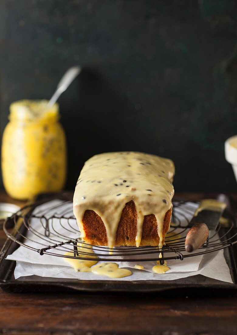 Passion fruit cake with icing on a wire rack