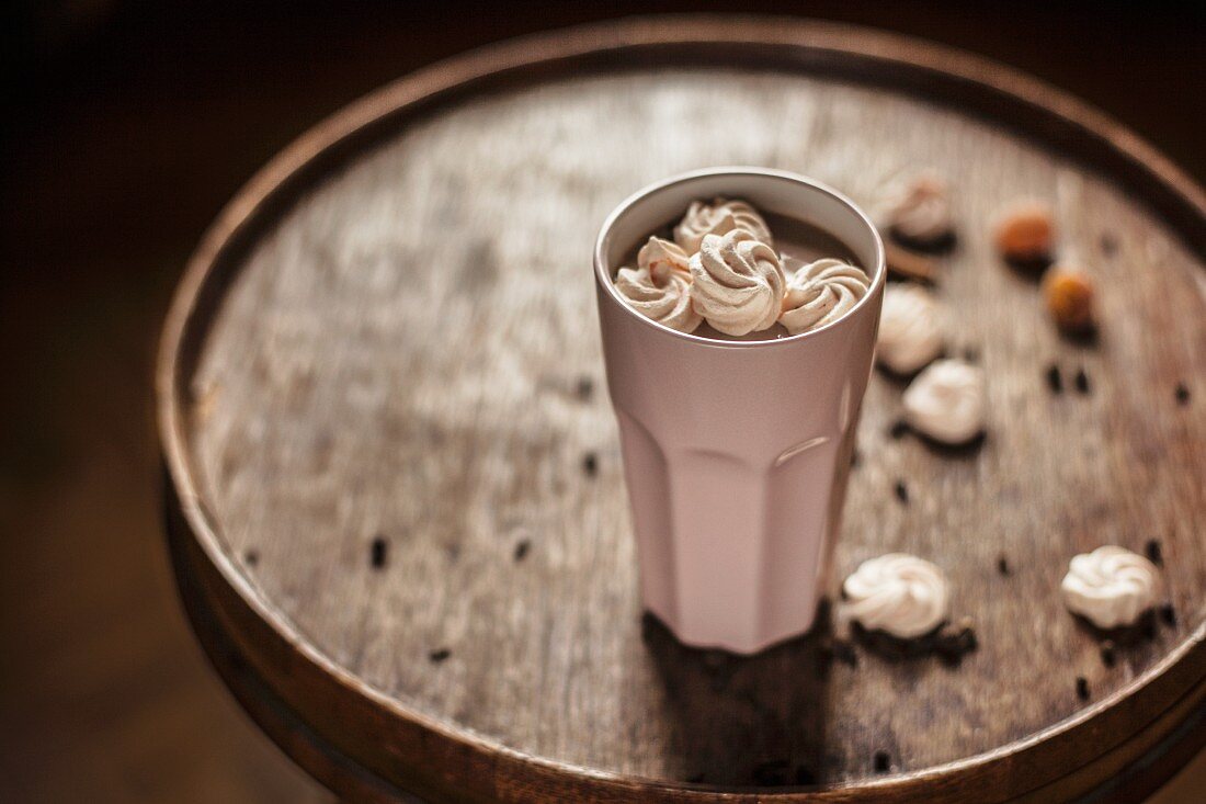 Hot chocolate with spices garnished with meringue